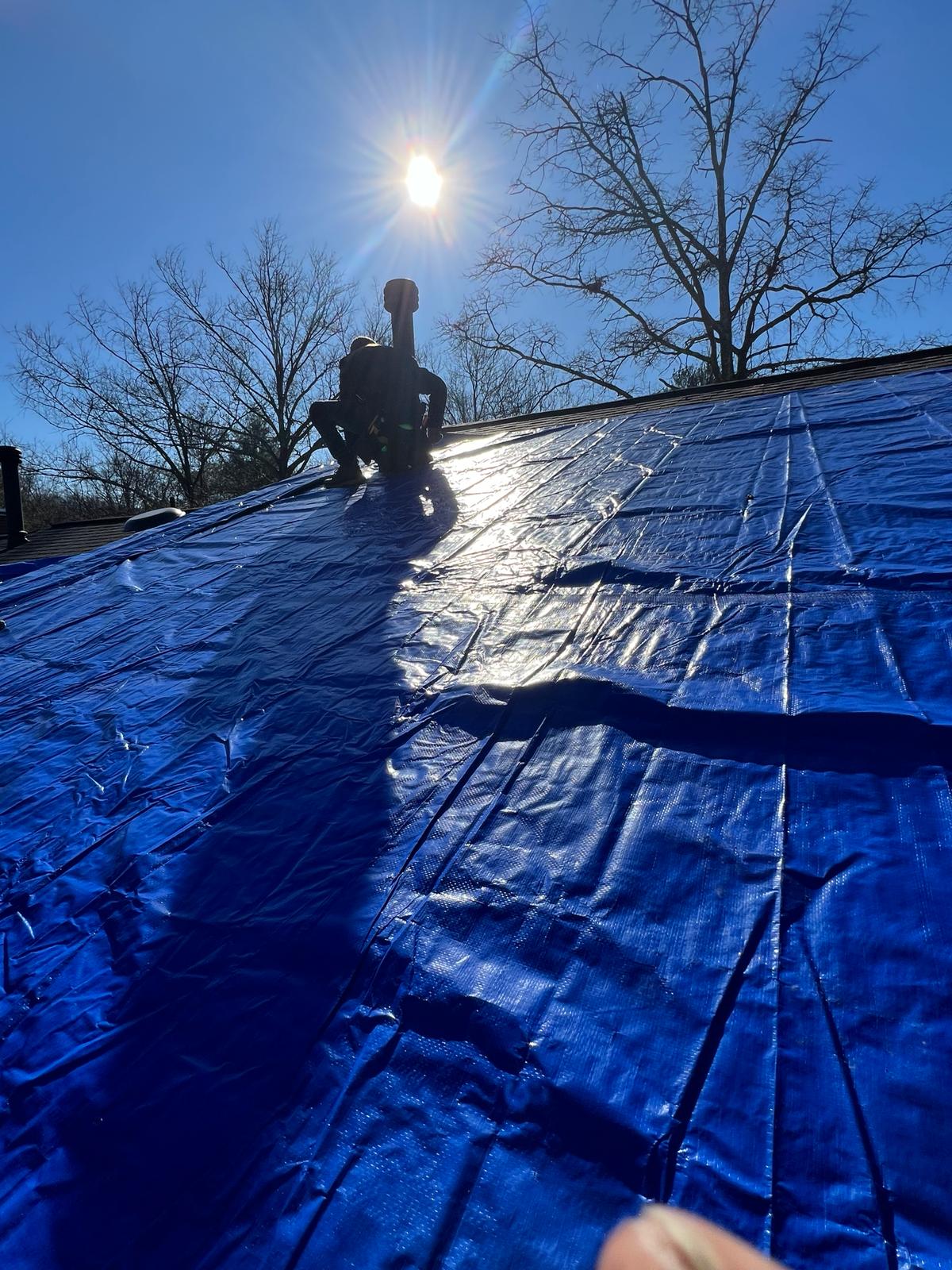 installing roof tarps to temporarily keep the water out in Columbia MD